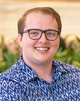 Gavin Graham sitting in an office and smiling.