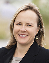 Woman wearing black suit in an outdoor setting