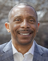 Headshot of Grady Smith in the office wearing a black blazer