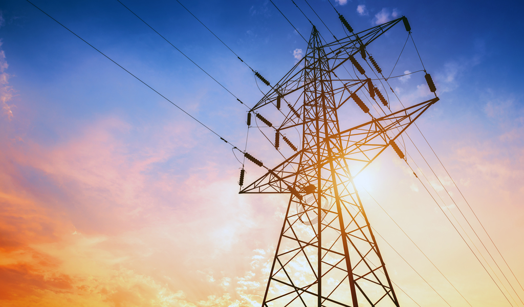 Transmission tower against a colorful sunset