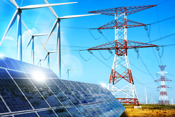 Wind turbines, transmission towers, and solar panels in a field.