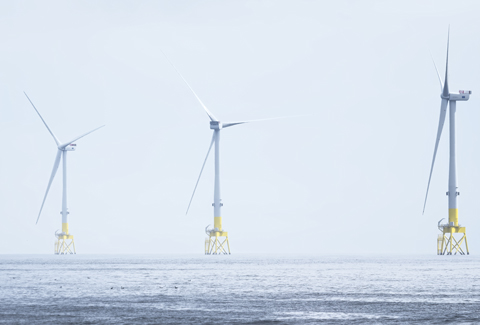 Wind turbines at electric power farm in the North Sea in Aberdeen for renewable energy production and environment conservation