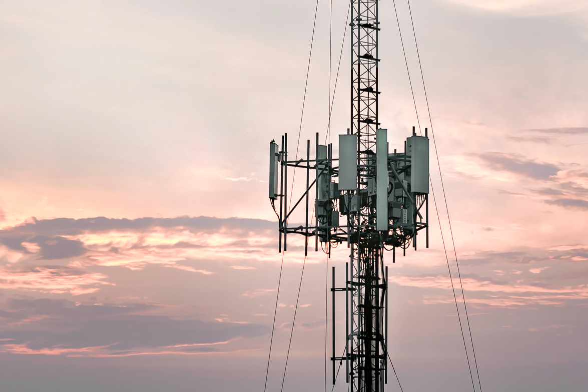 Telecommunications tower set against evening sky