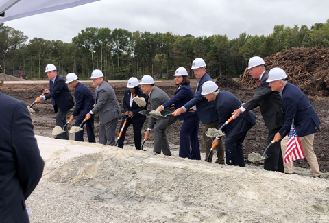 Project stakeholders hold shovels and move dirt to signify the groundbreaking of the new CBOC Hampton Roads.