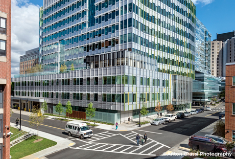 Multi-story building with glass façade in urban setting . 