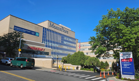 Exterior of a hospital emergency department and tower.