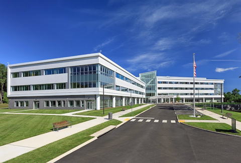 Circulation at the front entrance of the Sheltering Arms Hospital that includes sidewalks, a pedestrian crosswalk, and vehicle drop off.