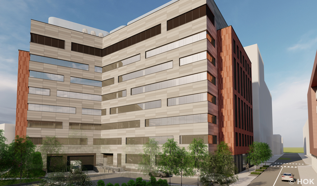 A slate-colored building surrounding a courtyard.