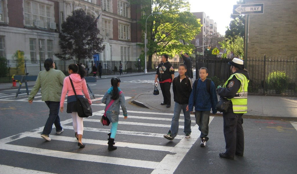 Children walking in a crosswalk on their way to school in New York City.