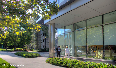 People walk along a path outside 300 Binney Street in Cambridge, Massachusetts.