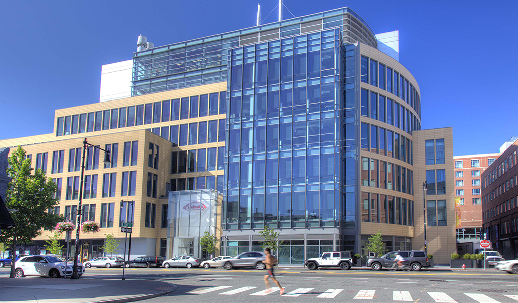 A jogger runs past Takeda’s new facility at 300 Massachusetts Avenue in Cambridge.