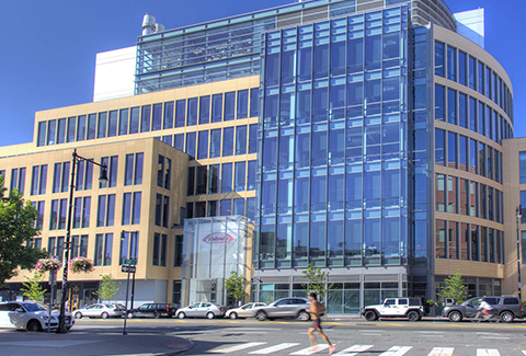 A jogger runs past Takeda’s new facility at 300 Massachusetts Avenue in Cambridge.