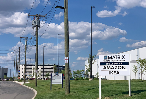 A sign welcomes Amazon and Ikea to the industrial park.