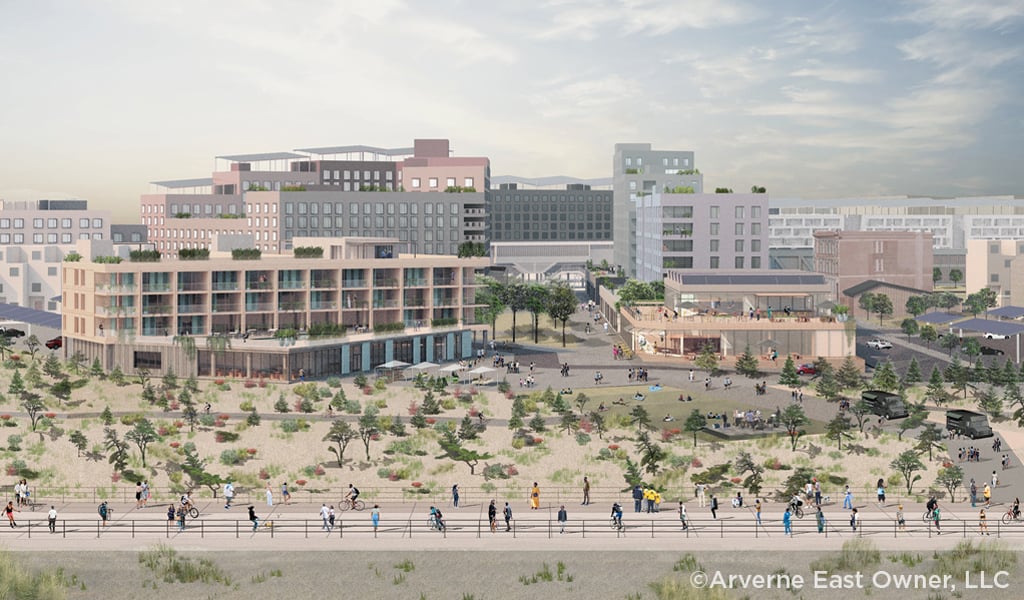 Pedestrians walking along the seashore development with new mix-used buildings.