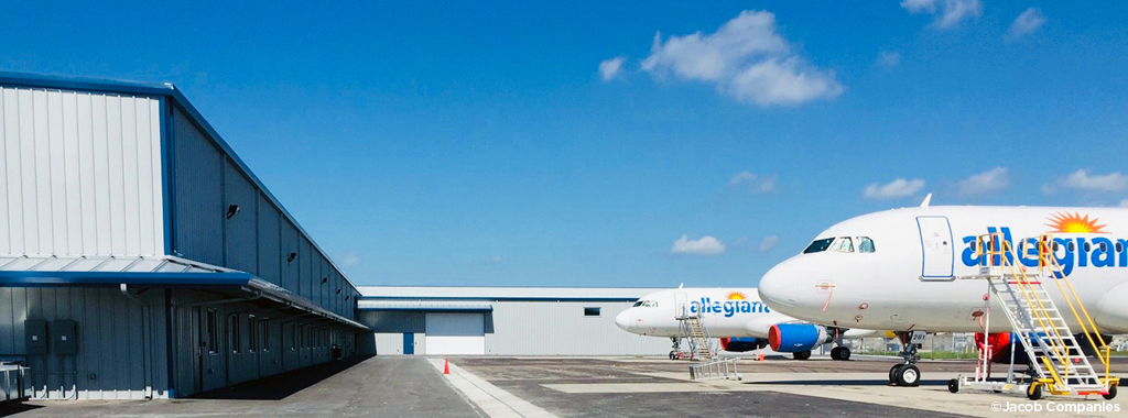 Two Allegiant airplanes sit parked outside the maintenance facility at St. Petersburg-Clearwater International Airport.