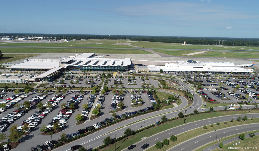 Drone photo of Myrtle Beach Airport terminal, runway, roadways, and parking areas.