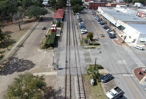 A train track through a rural city.