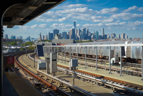 Train station platform in Brooklyn looking toward Manhattan skyline.