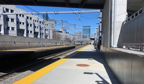 New rail platform with city view in background at Ruggles Station in Boston, Massachusetts.