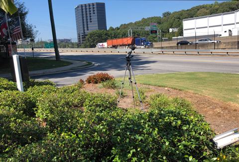 Noise assessment microphone stationed next to I-285 picking up the sounds of passing traffic.