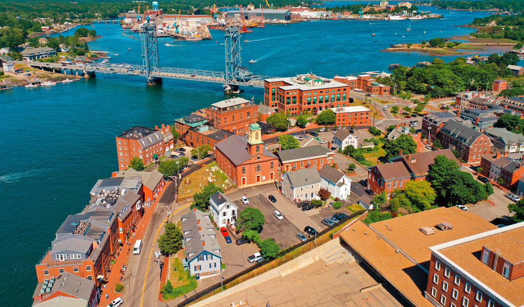 Portsmouth harbor with a view of industrial facilities lining the water.