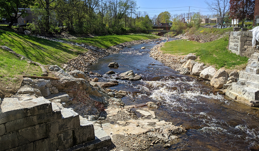 The now free-flowing Bellamy River runs between the remnants of the former upper dam.