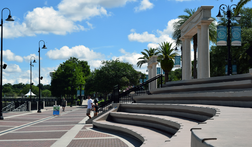 People walking down stone steps with columns.