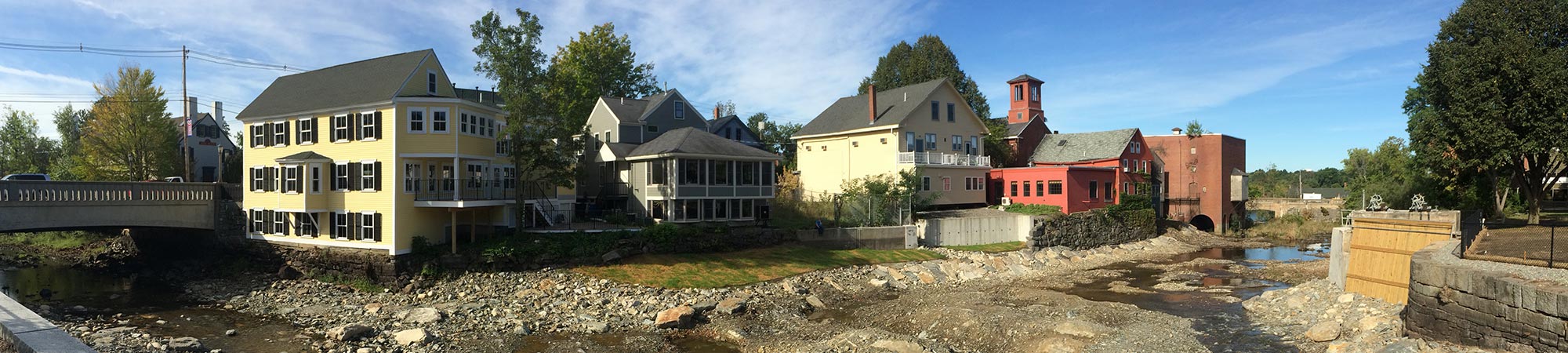 Houses line the bank of the Exeter River after the Great Dam has been removed.