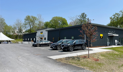 One-story building with cars in parking lot.