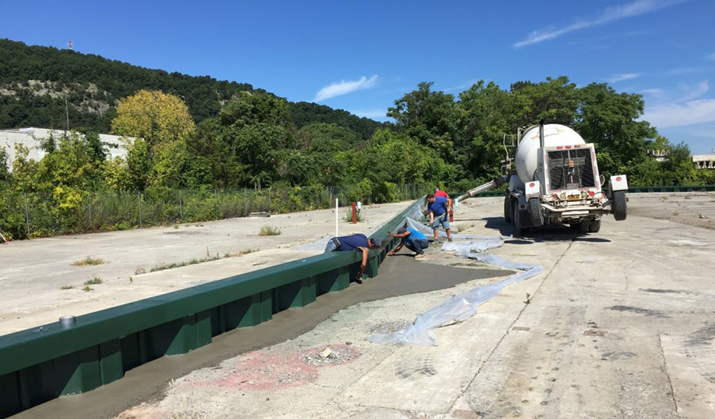 Workers installing sheet pile wall