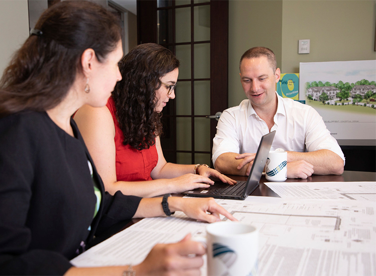 Staff discussing insurance matters in office.