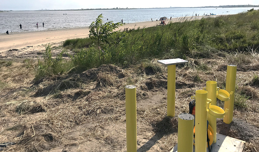 Image featuring groundwater monitoring wells next to beach