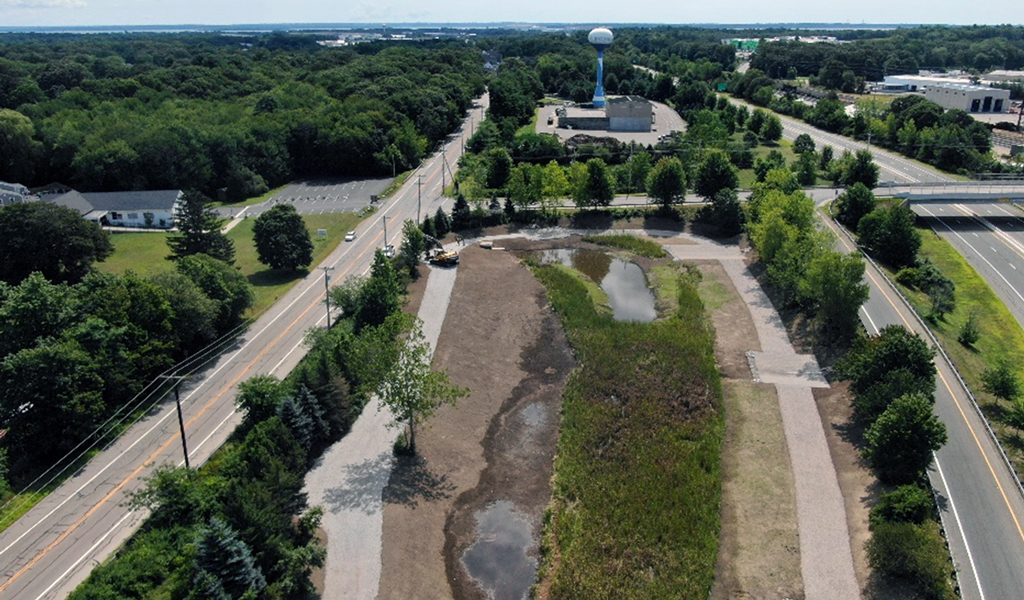 An aerial view of stormwater treatment units, separated from a road by greenery.