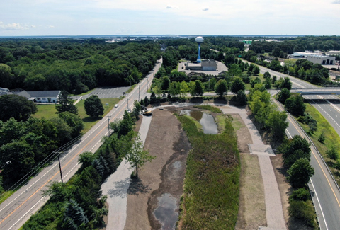 An aerial view of stormwater treatment units, separated from a road by greenery.