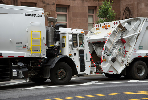 New York City Sanitation white street sweeper on the road. 