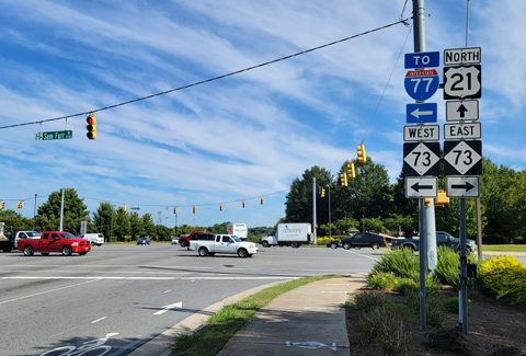 Cars moving through intersection. 