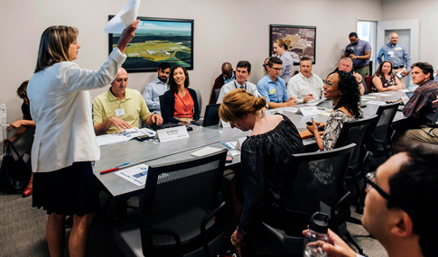 A group of people working around a conference table.