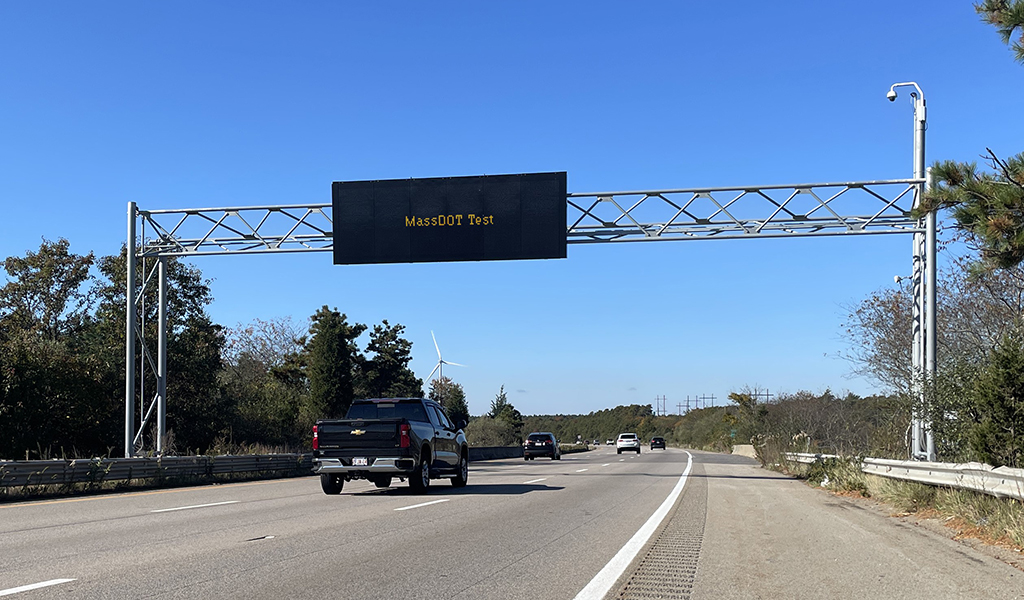 Highway overhead variable message sign that reads MassDOT test. 