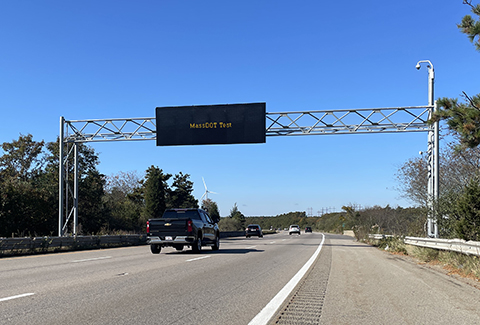 Highway overhead variable message sign that reads MassDOT test. 