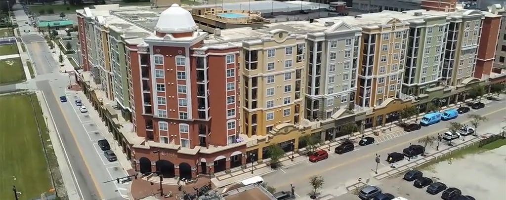 Aerial video of building and surrounding roads and development.