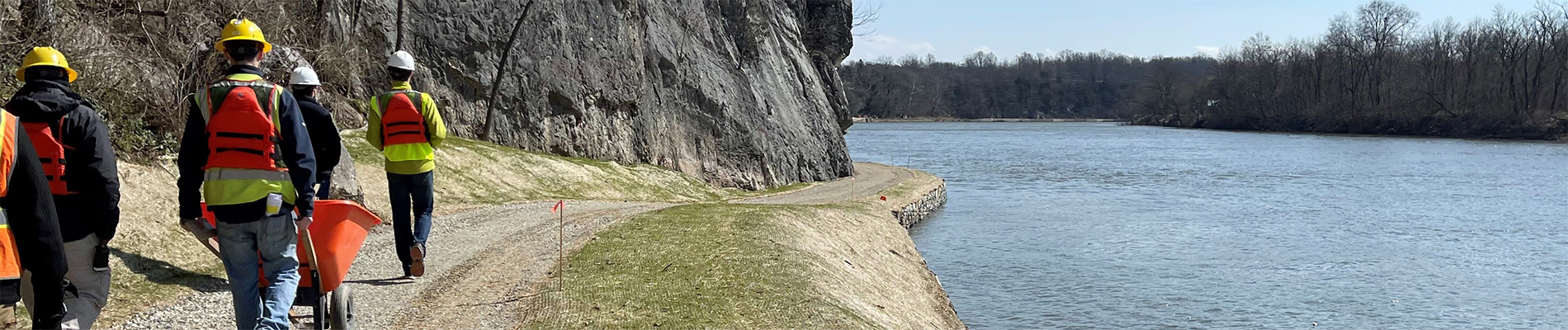 People walk along the tow path on a site visit.