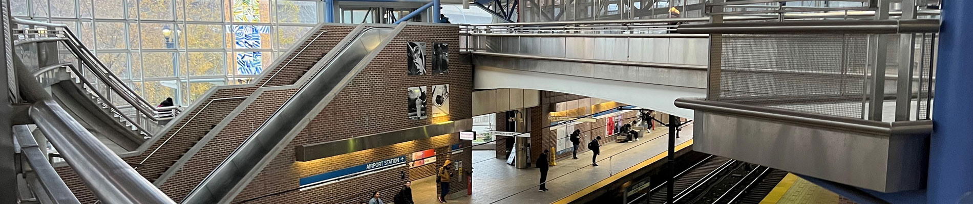 A train station with stairs and a bridge.