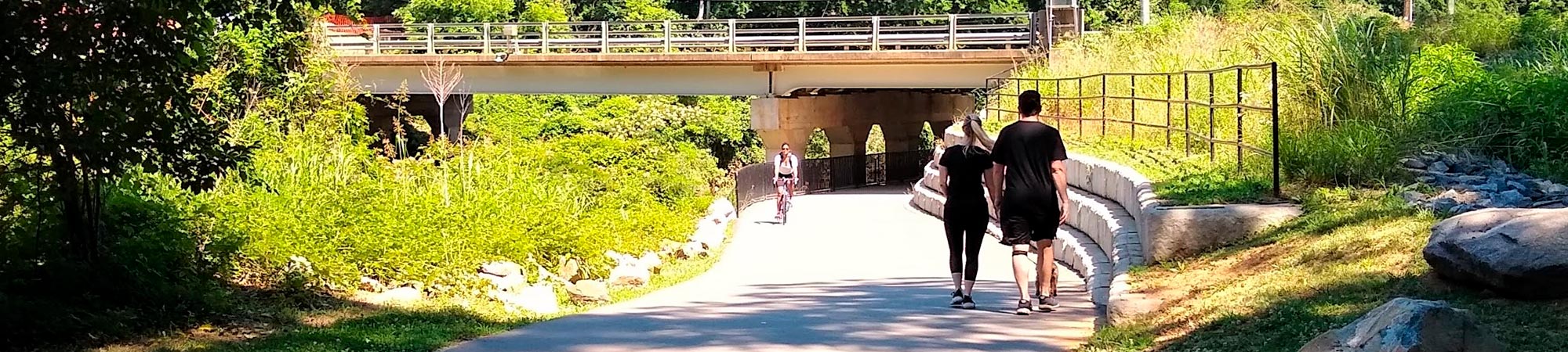 People walk and bike along a completed section of the Cross Charlotte Trail.