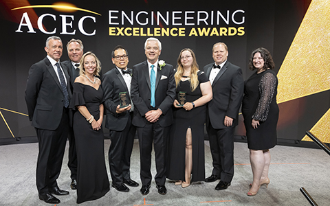 VHB employees stand with ACEC award