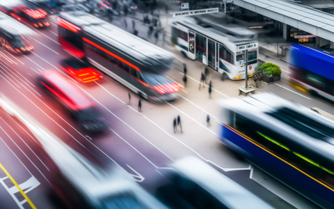 Digital illustration of mobility hub with blurred buses, trains, and pedestrians.