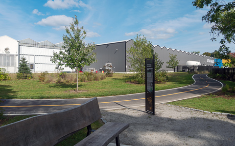 The new section of the Woonasquatucket River Greenway runs along the river and past the Gotham Greens greenhouse.