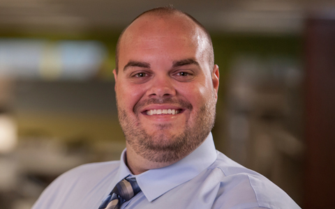 Kevin Freeman wears a tie in an office setting.