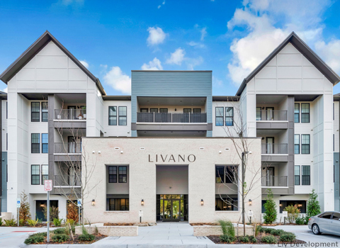 The Livano Apartments entrance building façade with plantings.
