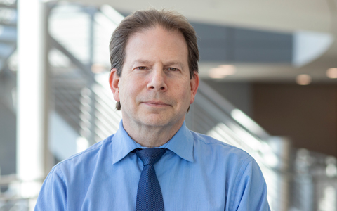 Michael Levine in a blue shirt and tie. 