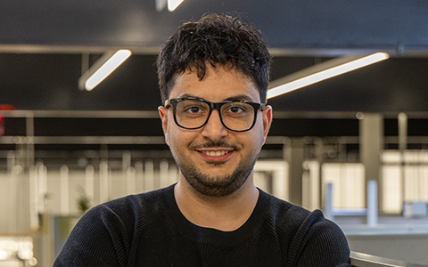 Nader Lobandi poses wearing a black shirt with arms crossed